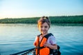 Little happy girl in a life jacket while walking on a boat Royalty Free Stock Photo