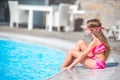 Little happy girl in outdoor swimming pool enjoy her vacation Royalty Free Stock Photo