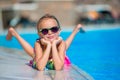 Little happy girl in outdoor swimming pool enjoy her vacation Royalty Free Stock Photo