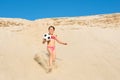 Little happy girl playing with a ball on the beach on a sunny day. Active lifestyle, games, vacations, vacations Royalty Free Stock Photo