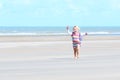 Little happy girl playing on the beach Royalty Free Stock Photo