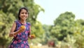 Little happy girl playing with fresh Orange. blurred green background, copy space Selective focus