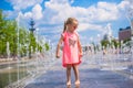 Little happy girl playing in open street fountain Royalty Free Stock Photo