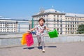 The little happy girl with purchases runs on a meeting to parents Royalty Free Stock Photo