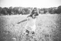 Little happy girl in a purple flower field