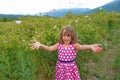 Little happy girl in valley of roses throw petals Royalty Free Stock Photo