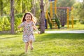 Little happy girls on a walk on a summer evening at sunset in the park. Sisters Royalty Free Stock Photo