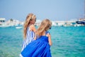 Little happy girls in dresses at street of typical greek traditional village on Mykonos Island, in Greece Royalty Free Stock Photo