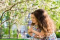 Little happy girls on a walk on a summer evening at sunset in the park. Sisters Royalty Free Stock Photo