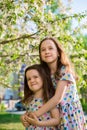 Little happy girls on a walk on a summer evening at sunset in the park. Sisters Royalty Free Stock Photo