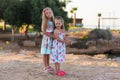 Little happy girls on a walk on a summer evening at sunset in the park. Sisters. Summer time. holidays Royalty Free Stock Photo