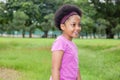 Little happy and joyful African American girl playing in the park. Royalty Free Stock Photo