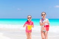 Little happy kids have a lot of fun at tropical beach playing together Royalty Free Stock Photo