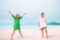 Little happy kids have a lot of fun at tropical beach playing together Royalty Free Stock Photo