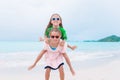 Little happy kids have a lot of fun at tropical beach playing together Royalty Free Stock Photo