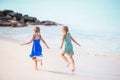 Little happy kids have a lot of fun at tropical beach playing together Royalty Free Stock Photo