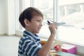 A little happy smart Caucasian boy holding a model airplane in his hand Royalty Free Stock Photo