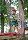 A little happy and smiling rock climber tie a knot on a rope. A person is preparing for the ascent. The child learns to tie a knot Royalty Free Stock Photo