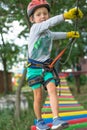 A little happy and smiling rock climber tie a knot on a rope. A person is preparing for the ascent. The child learns to tie a knot Royalty Free Stock Photo