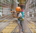 A little happy and smiling rock climber tie a knot on a rope. A person is preparing for the ascent. The child learns to tie a knot Royalty Free Stock Photo