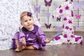 Little happy toddler girl celebrating first birthday. Cute baby girl sitting with big 1 and  candy Royalty Free Stock Photo