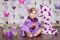 Little happy toddler girl celebrating first birthday. Cute baby girl sitting with big 1 and vase whith candy Royalty Free Stock Photo