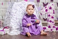 Little happy toddler girl celebrating first birthday. Cute baby girl sitting with big 1 anf box gift Royalty Free Stock Photo