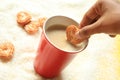 Little heart biscuit dipping into the coffee cup Royalty Free Stock Photo