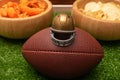 Little helmet american football ball and snacks on green grass