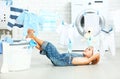 little helper tired child girl to wash clothes and rest in laundry Royalty Free Stock Photo