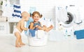 Little helpers funny kids happy in laundry to wash clothes, pla Royalty Free Stock Photo