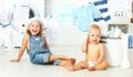 Little helpers funny kids happy sister and brother in laundry to Royalty Free Stock Photo