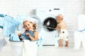 Little helpers funny kids happy sister and brother in laundry to Royalty Free Stock Photo