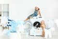 Little helpers funny kids happy sister and brother in laundry to