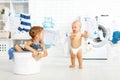 Little helpers funny kids happy sister and brother in laundry to Royalty Free Stock Photo