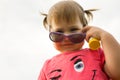 Little hild girl playing in park in front of green grass Royalty Free Stock Photo