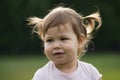 Little hild girl playing in park in front of green grass Royalty Free Stock Photo