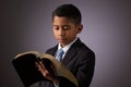 Little Hispanic Boy Reading the Holy Scriptures, The Bible, The Word of God Royalty Free Stock Photo