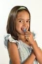 Little Hispanic Girl Flossing her Teeth Royalty Free Stock Photo