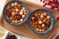 Homemade red and white tangyuan with syrup soup, dried longan pulp, red dates for Winter solstice Royalty Free Stock Photo