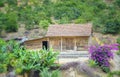 Little house on a hillside with paper flowers adorn