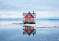 A little house in the middle of the water with mountains in the background. Color palette with the essence of nature. Winter time