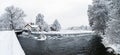 Little house next to a river in winter.