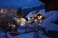 A little house in the snow, covered with Christmas lights Royalty Free Stock Photo