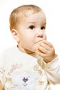 Little hungry boy eating doughnut