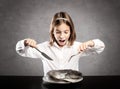 Little hungry girl in front of a whole raw fish Royalty Free Stock Photo