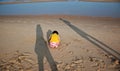 Little hurt child and parents shade on the beach