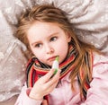 Ill girl measuring temperature Royalty Free Stock Photo