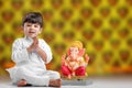 Little Indian boy with lord ganesha , Celebrating Ganesh Festival
