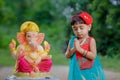 Little Indian girl child with lord ganesha and praying , Indian ganesh festival Royalty Free Stock Photo